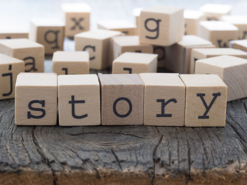 What are the power of stories in our lives? (An image of wooden blocks with letters spelling the word story.)